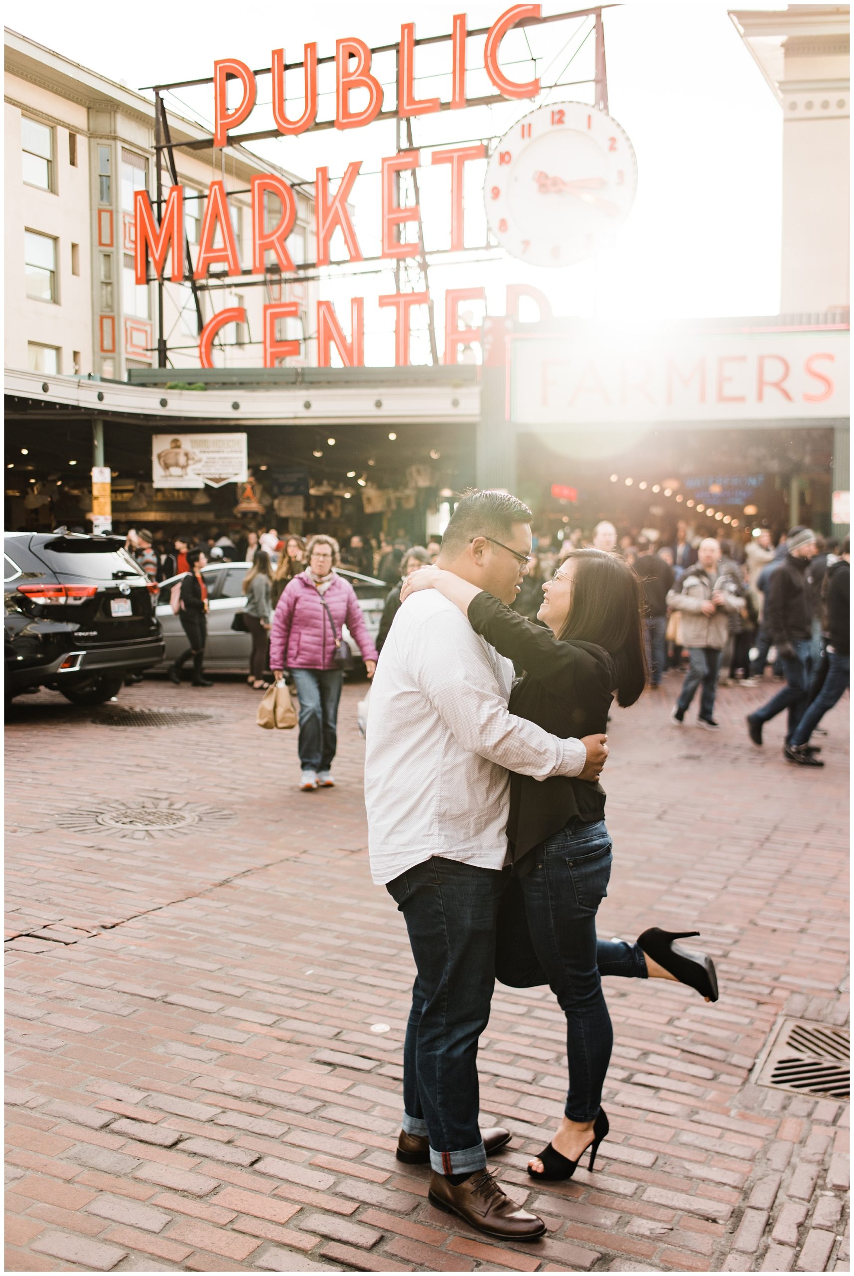 Pike Place engagement session ideas, couple embracing in front of the Pike Place Market sign