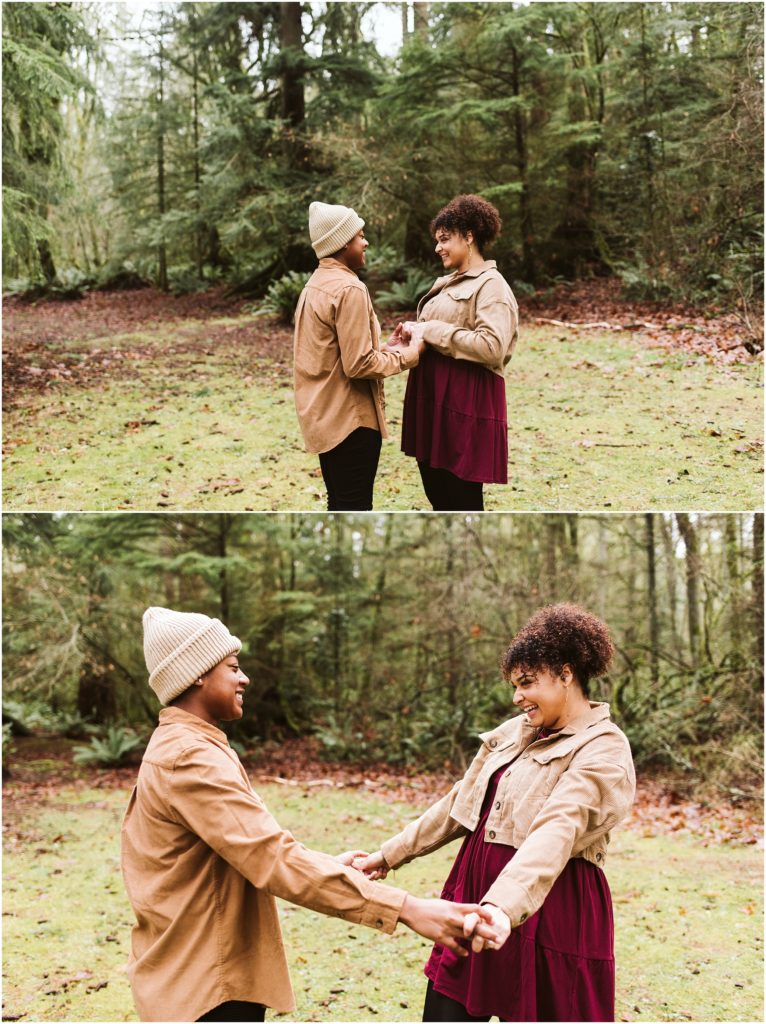 An LGBTQ+ couple holding hands and smiling at one another during their Point Defiance engagement session
