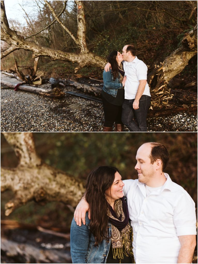 An engaged couple embracing, kissing, and laughing during their Seahurst Park engagement session