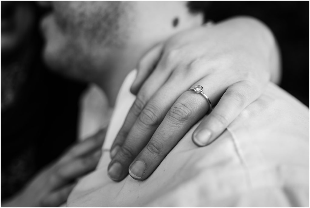 Close up of an engagement ring during a couple's embrace during their Seahurst Park engagement session
