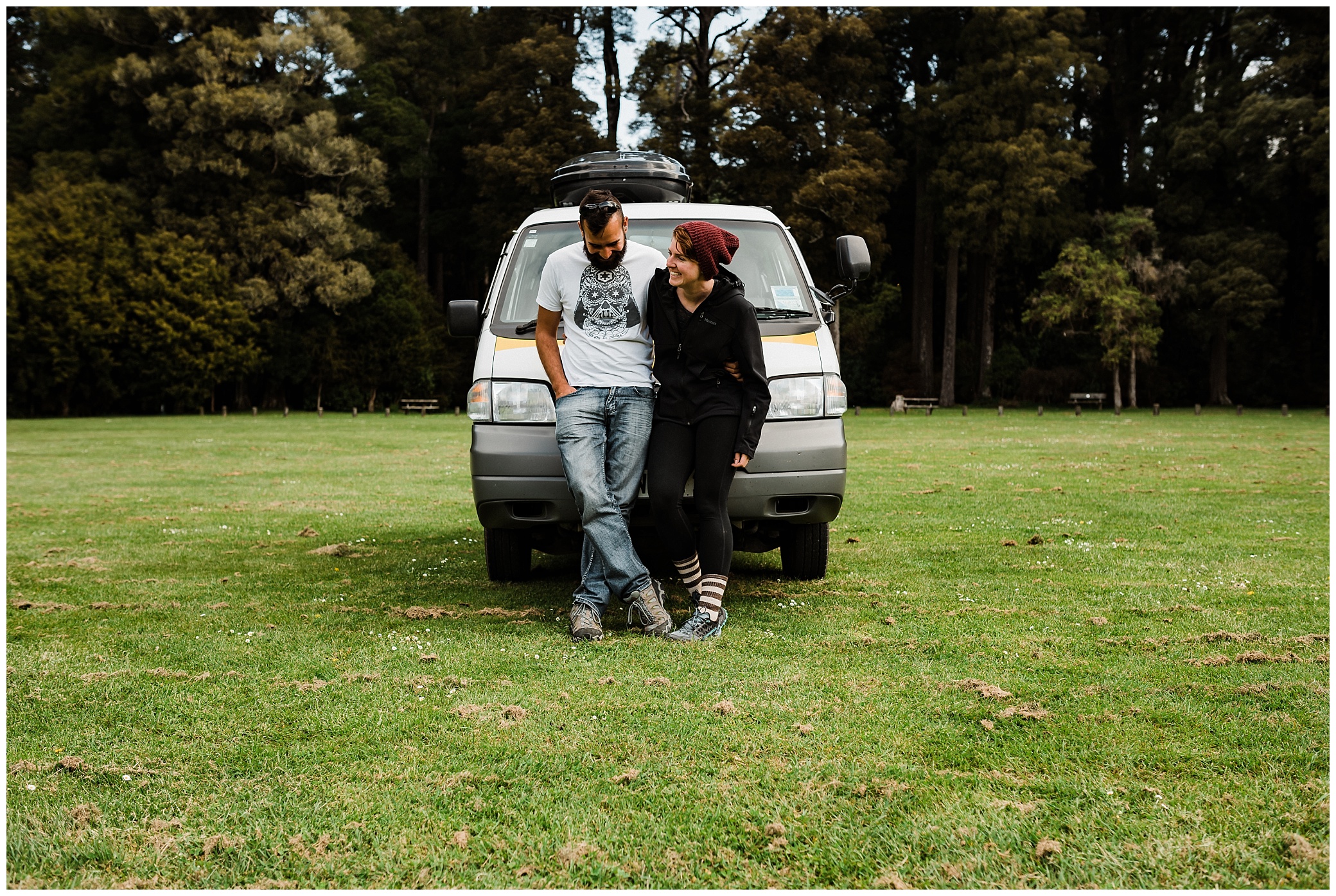 How to travel New Zealand in a campervan, DOC campsite, laughing in front of the campervan
